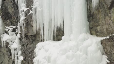 Mainline,-Mount-Kineo-frozen-ice-cascade-ascending-cliff-aerial-4K