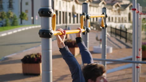 person doing pull-ups on outdoor gym equipment