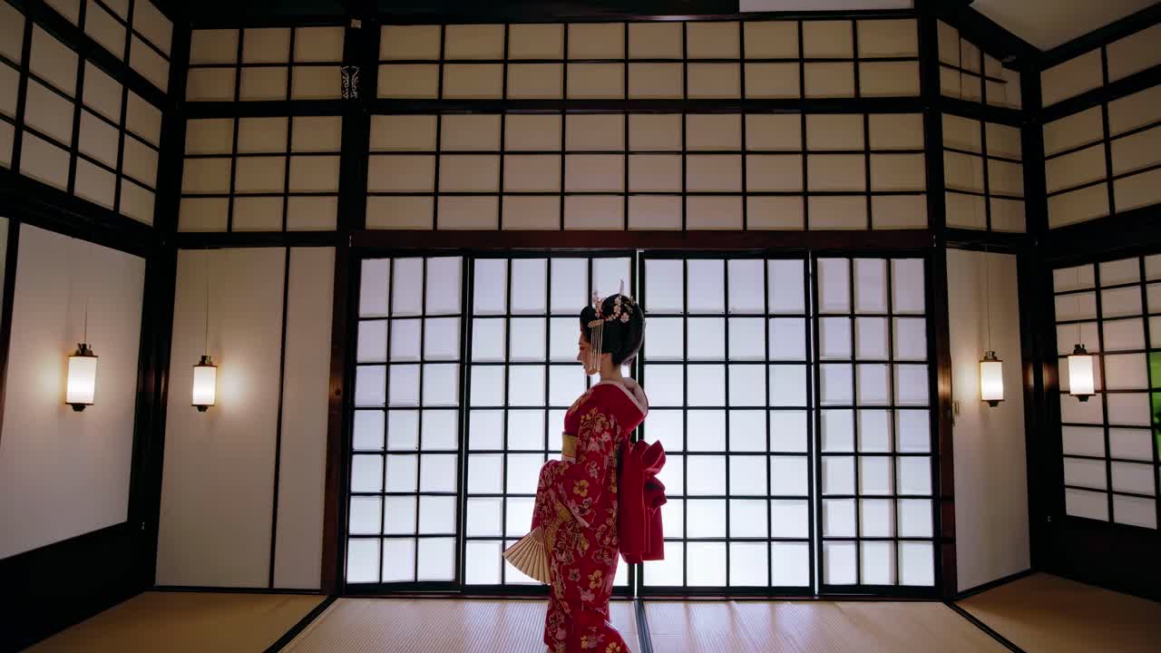 Profile view of a woman in traditional attire, set against a shoji screen