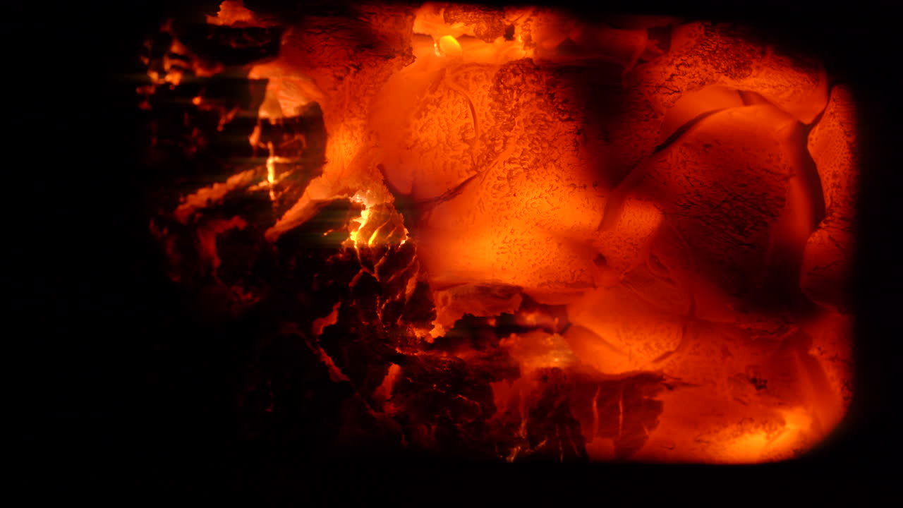 Hot fiery embers glowing and flaming close up with a black background