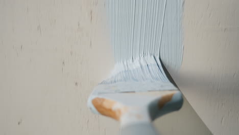 pov - builder paints a wall