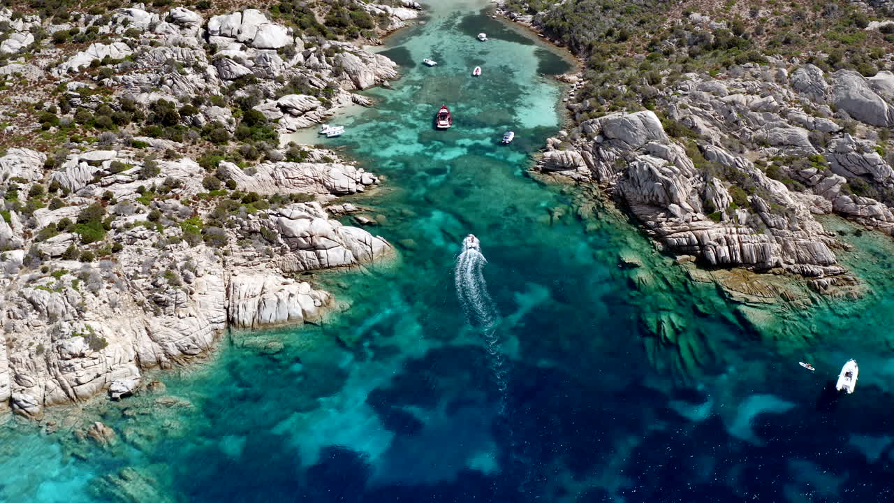 Bateau entrant dans une petite cala privée sur l'île de Caprera, Sardaigne, Italie