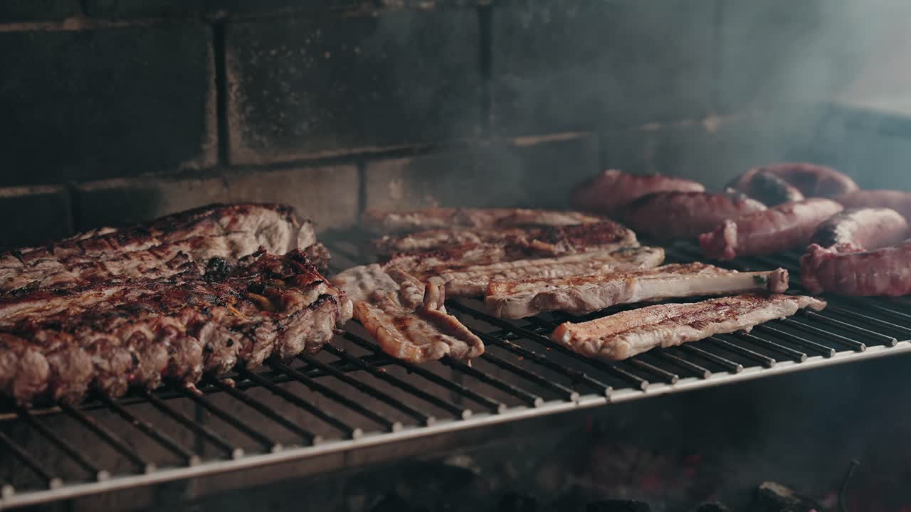 assorted meat cuts sizzling on smoky grill over glowing charcoal flames