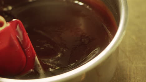 closeup liquid chocolate making in slow motion. macro of stirring chocolate