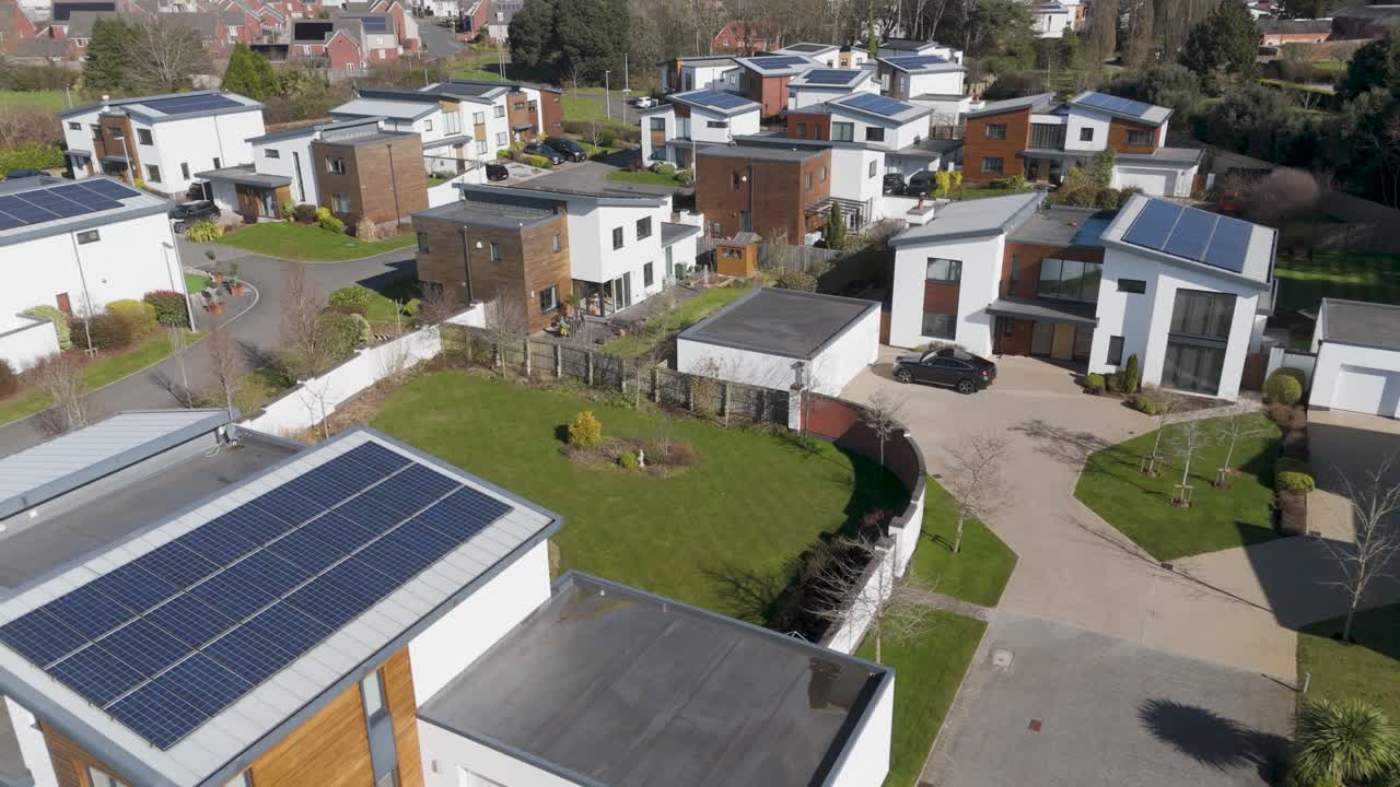 Aerial panorama of mixed material white-and-timber homes in cul-de-sacs, garages and tree buffers illustrating family-oriented sustainable development