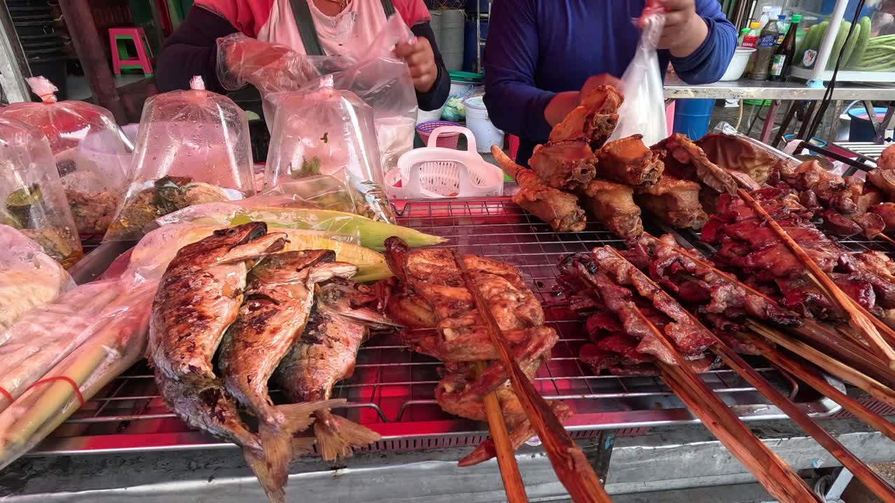 Vendor grilling and selling skewered meats