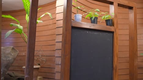 black board in wooden plant stand bottom to top closeup view