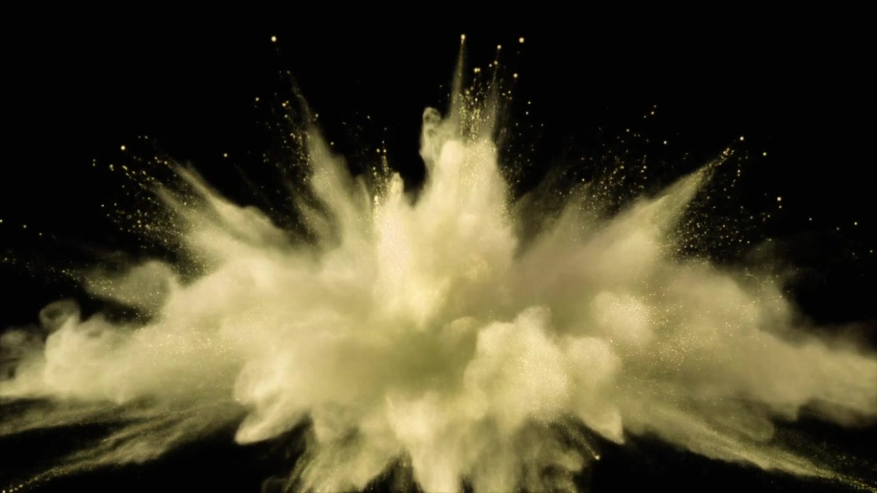 Golden Powder Explosion Against Black Background