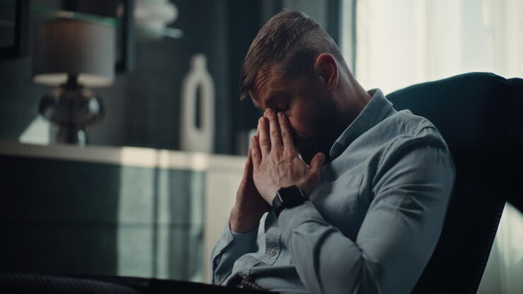 Sad Professional Stock Exchange Trader Monitoring Real-Time Stocks and Exchange Market Charts on Laptop, Suffering from Financial Crisis. Investment Agent Stressed About Sudden Stock Market Collapse.