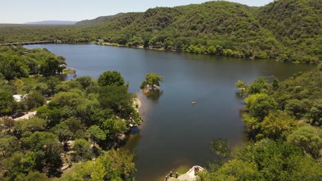 Yellow-kayak-on-lake-surrounded-by-green-vegetation,-Cordoba-in-Argentina