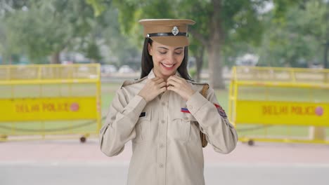 happy indian female police constable wearing hat