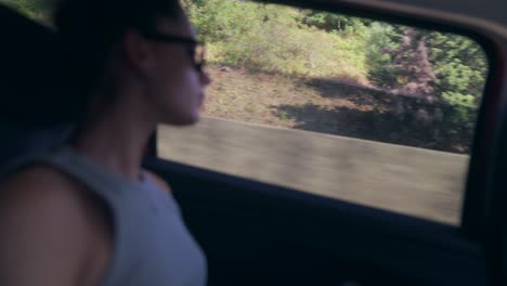 person looking out car window on a road trip