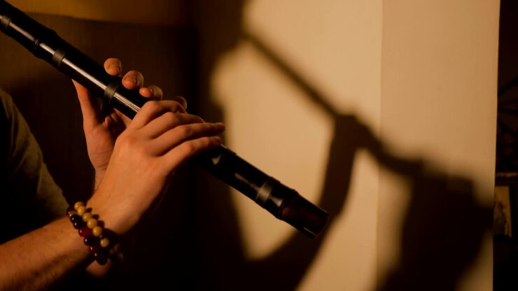 Man playing japanese bamboo flute - shakuhachi