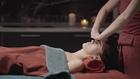 woman receiving a facial massage at a spa