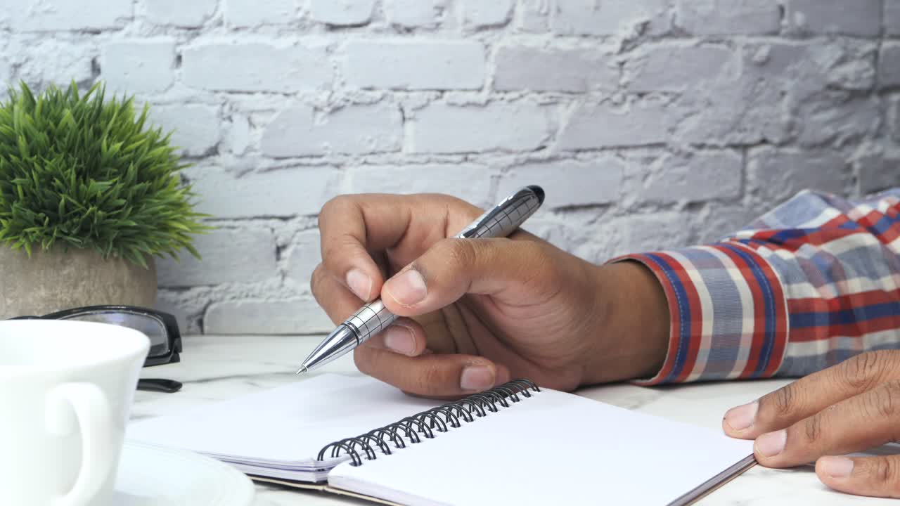 Person taking notes at a desk