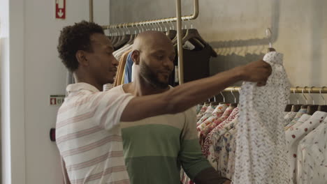 Black-male-couple-looking-at-shirts-in-clothing-shop.