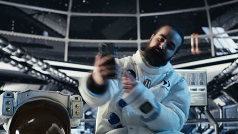 astronaut records selfie video with smartphone, speaking to subscribers