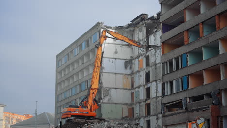 destroying old house with machine. demolition of the old industrial building