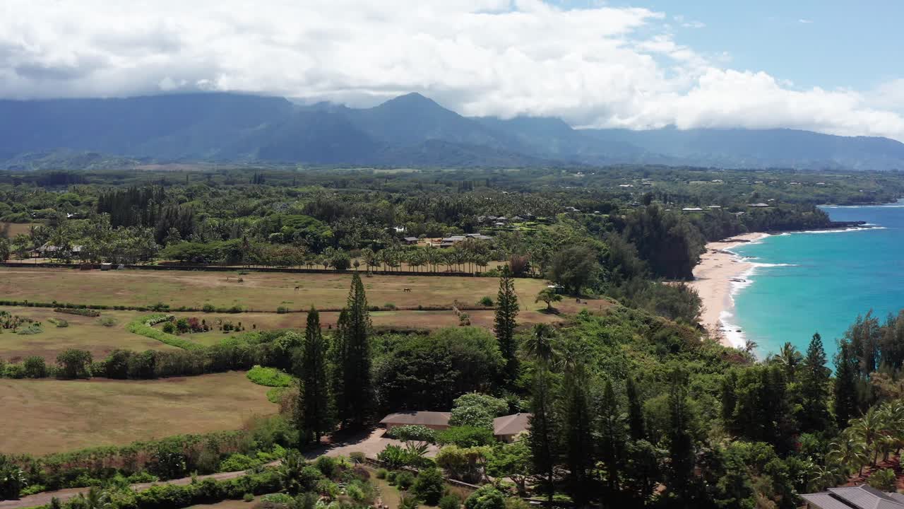 Low aerial dolly shot of the Kaua'i North Shore coastline near Princeville in Hawai'i