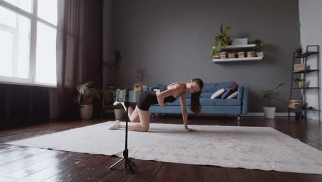 wide shot of a happy young female influencer teaching an online fitness class