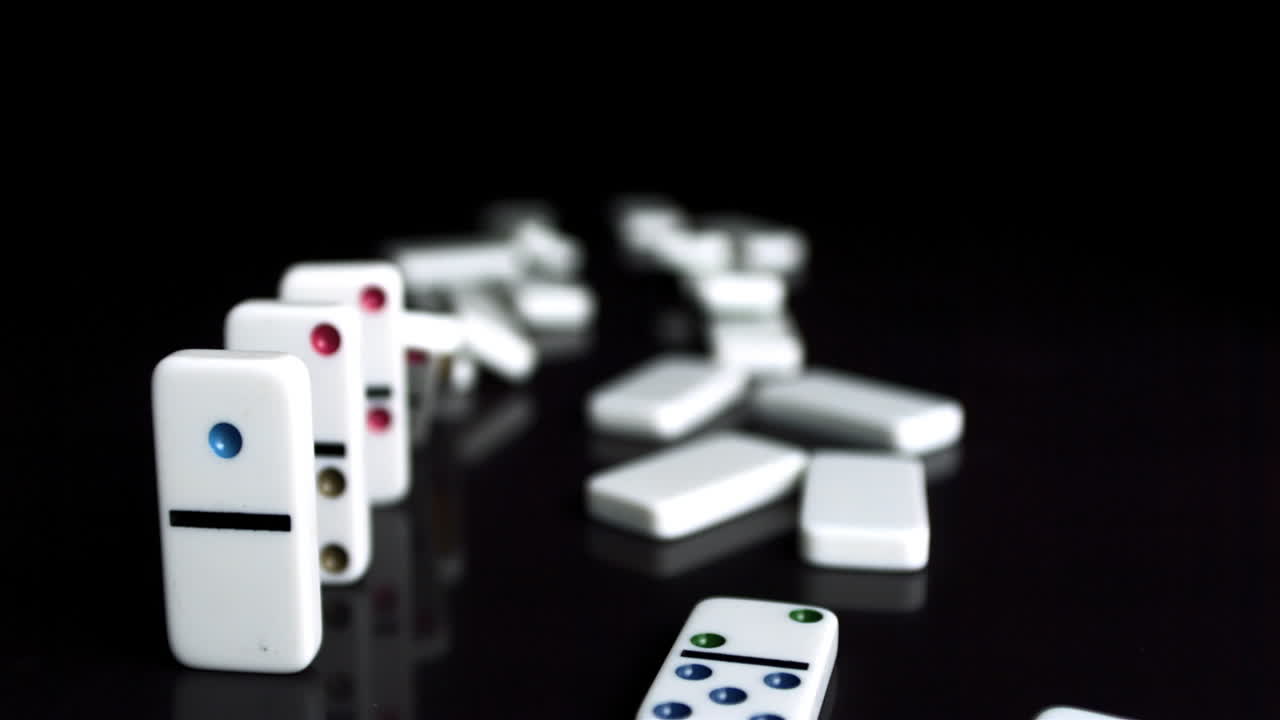 Line of dominoes falling down