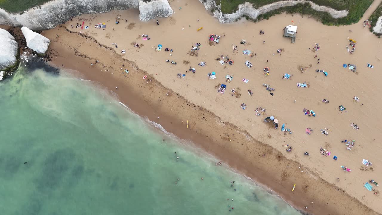 Aerial view of a crowded beach with white cliffs