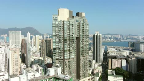 Aerial-shot-of-Downtown-Hong-Kong-mega-residential-skyscrapers-and-traffic,-on-a-beautiful-day