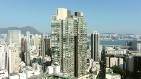 aerial shot of downtown hong kong mega residential skyscrapers and traffic, on a beautiful day