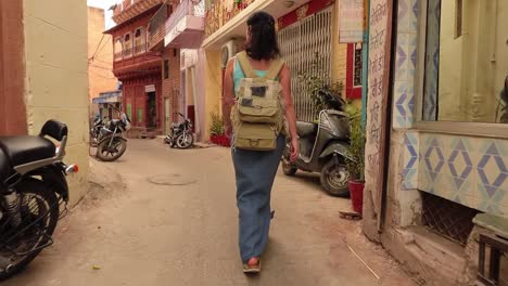 Female-tourist-walks-through-the-streets-of-an-Indian-city.-Rajasthan,-Indian-Jodhpur-Also-blue-city