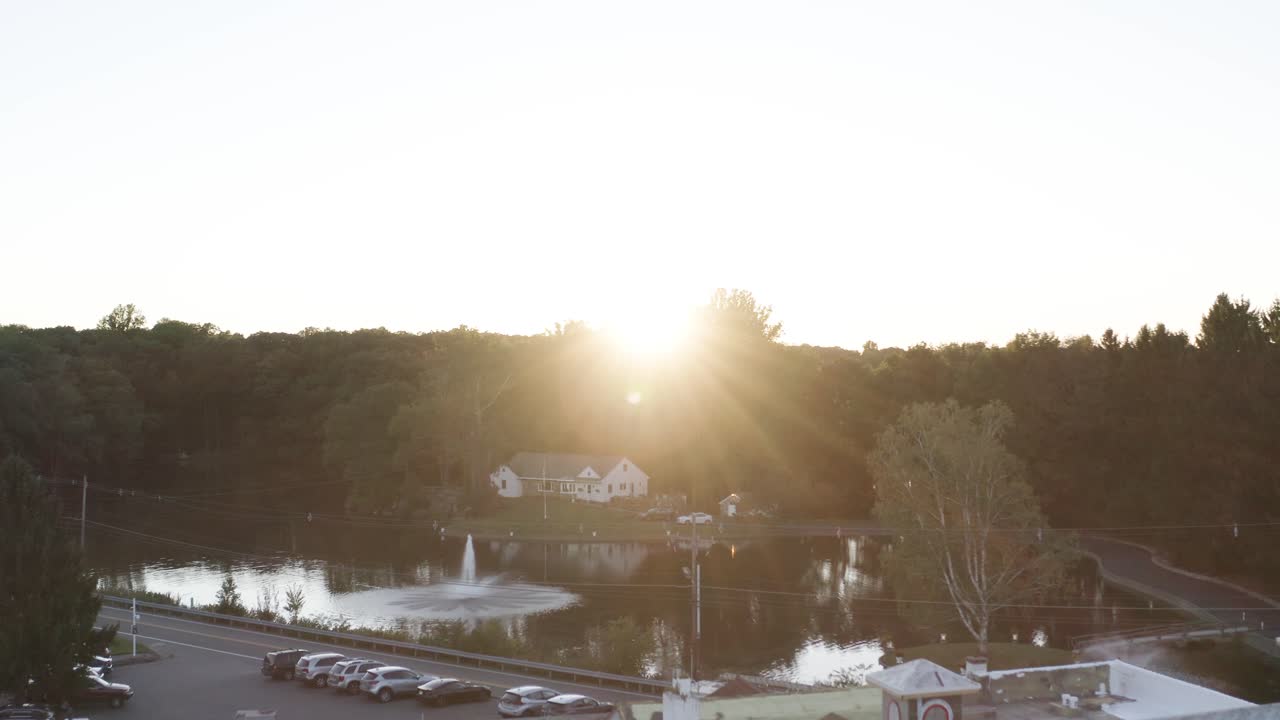 Low angle drone view of luxurious mansion and sunset reveal