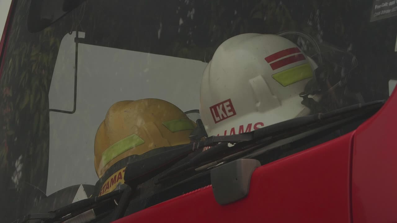 2 fireman hats in the dashboard of a truck