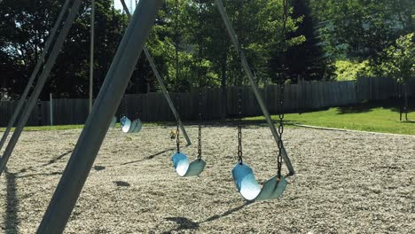 empty swings at a park, zoom in