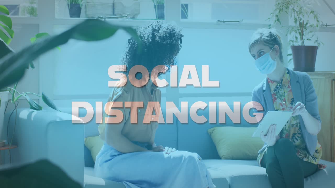 Animation of words social distancing with colleagues in office wearing face masks