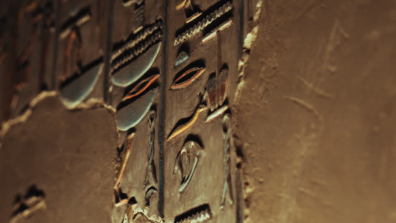 A detailed close view of carved hieroglyphs on stone, reflecting the precision and sacred artistry of pharaonic inscriptions