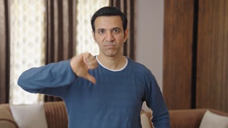 disappointed indian father showing thumbs down