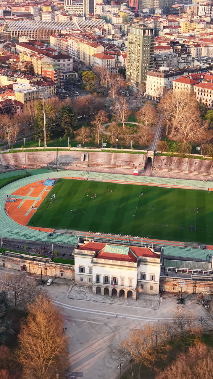 Aerial drone view of the Arena Civica surrounded by buildings in Milan, Italy. Vertical