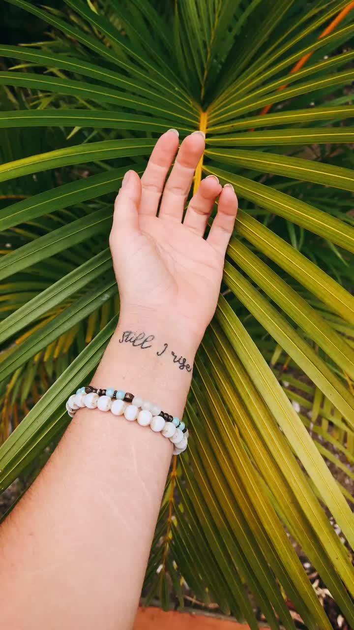 Wrist Tattoo with "Still Rising" Quote