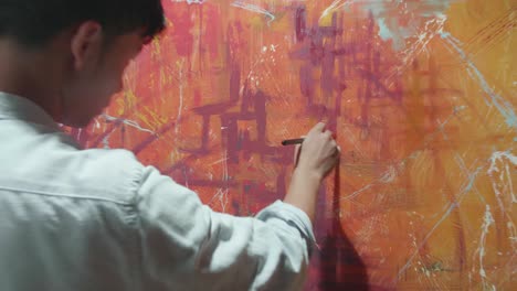 male artist painting abstract picture