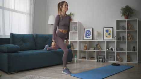 La-Mujer-Está-Haciendo-Ejercicios-Para-Los-Músculos-De-Las-Piernas-En-La-Sala-De-Estar,-Cuerpo-Femenino-Deportivo,-Entrenamiento-En-Casa-Y-Fitness-En-Autoaislamiento-Durante-Una-Pandemia