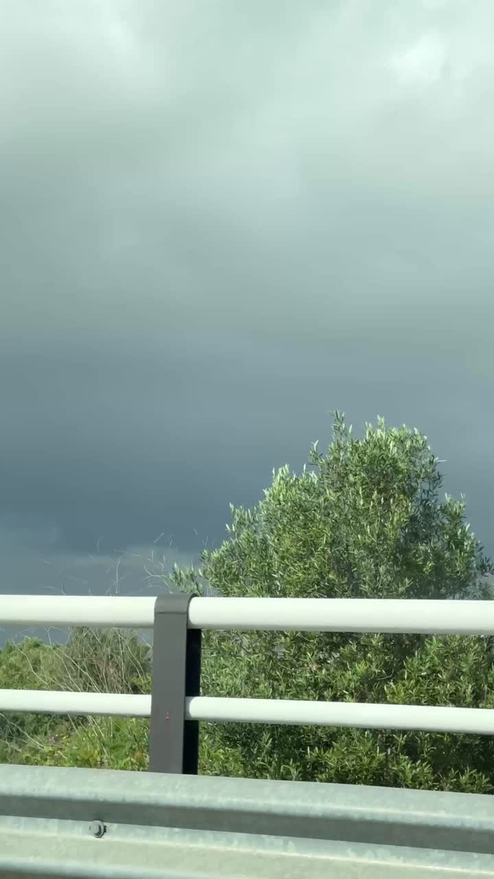 Cloudy Sky over Highway and Cityscape