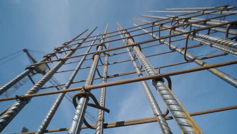 steel frames of a building under construction, with tower crane on top