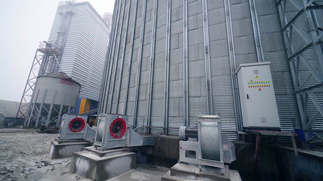 Large silver granary. Storage of grain in the background of winter