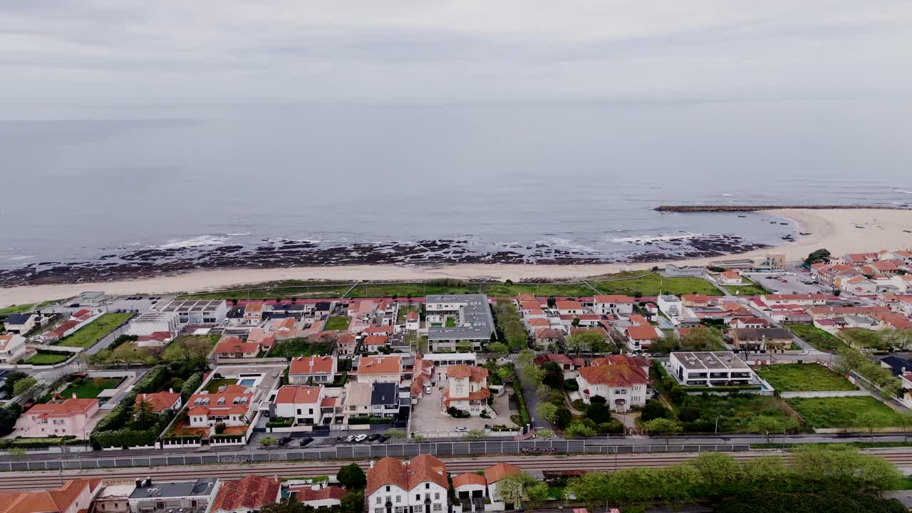 aerial coastal neighborhood with sea horizon and beach waves