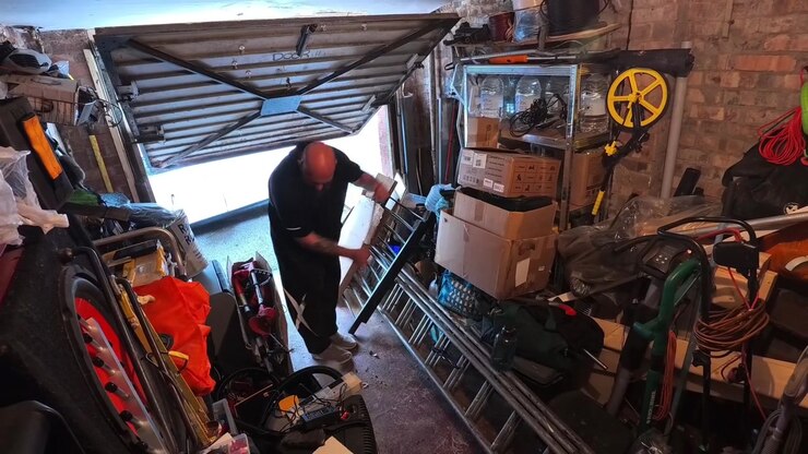 Timelapse di un uomo che riordina un accumulo disordinato di oggetti domestici, organizzando il contenuto del garage