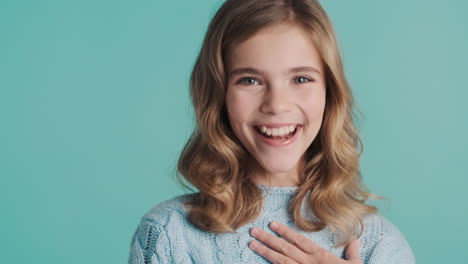 teenage caucasian girl nodding and smiling at the camera.