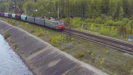 freight train crossing a river landscape