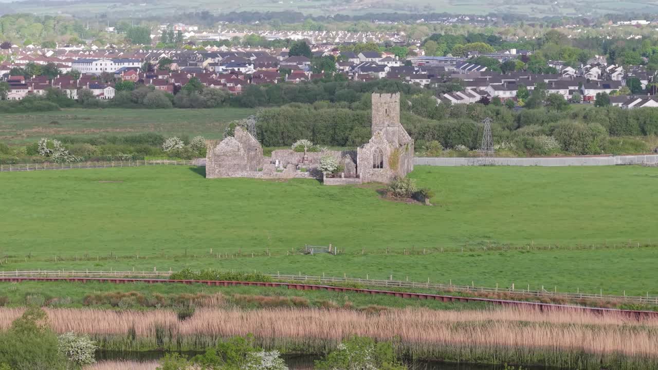 Ruins of Clare Abbey with scenic landscape near Ennis, Ireland