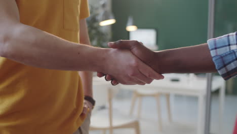 close up of african american and caucasian men shaking hands