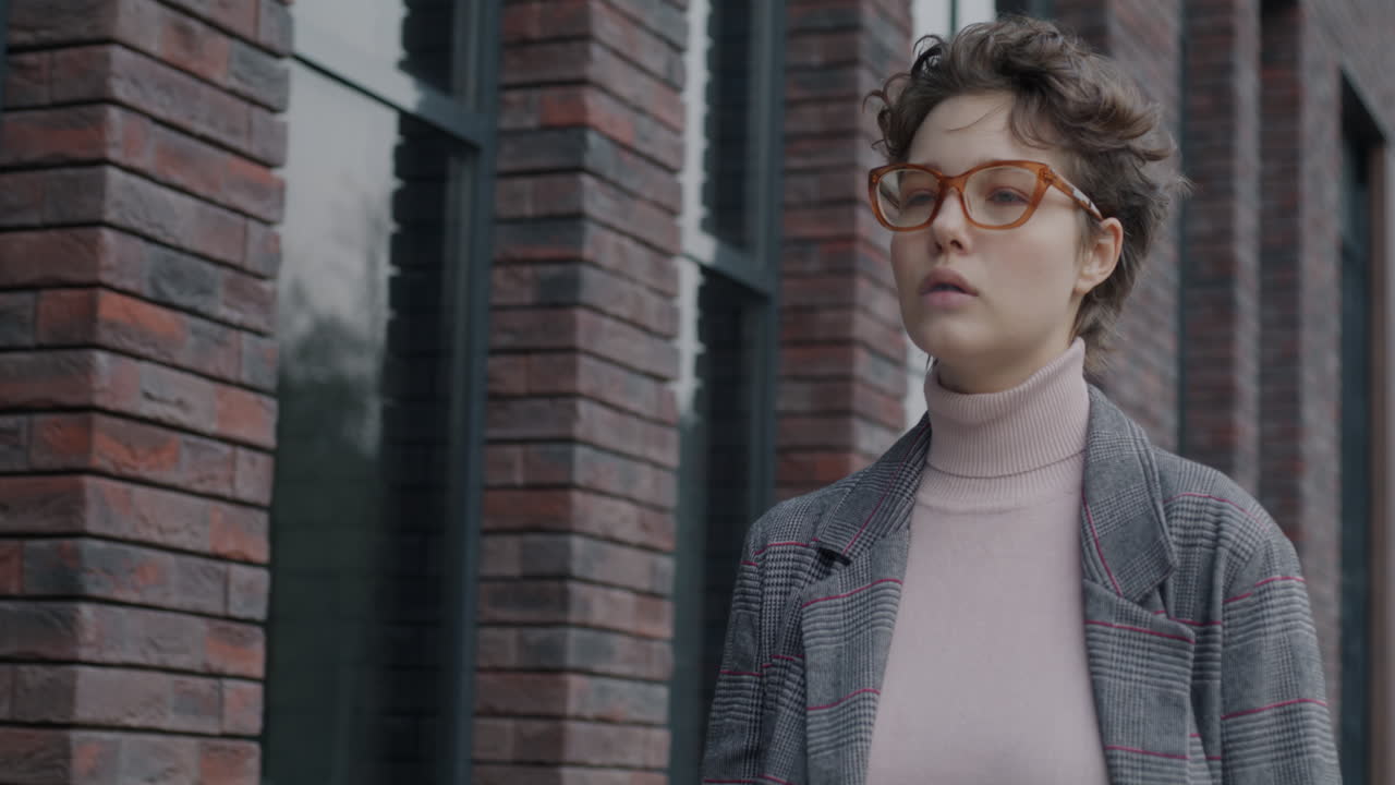 Woman walking outdoors, smoking a cigarette