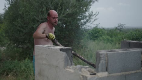man working on outdoor construction site with concrete